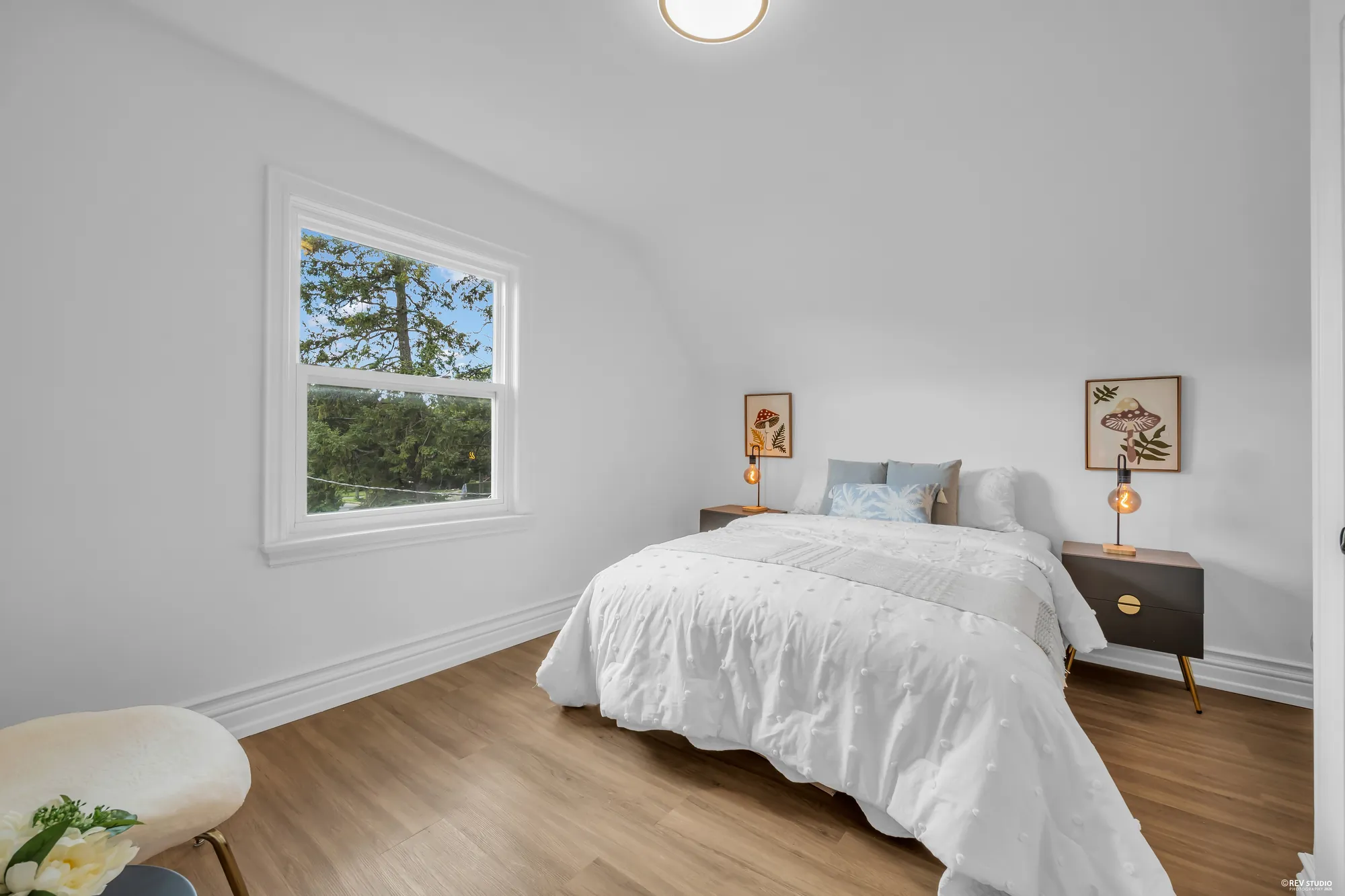 The second upstairs bedroom looking toward the window over the trees
