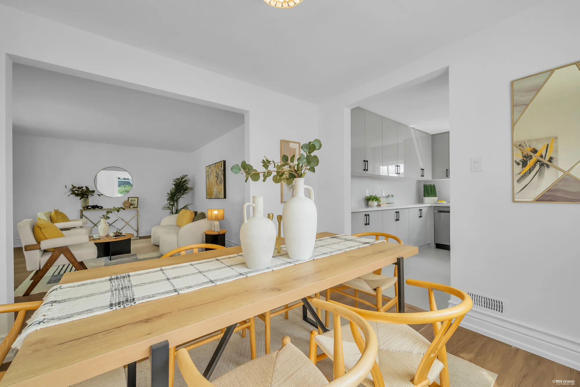 The dining table with the living room beyond it