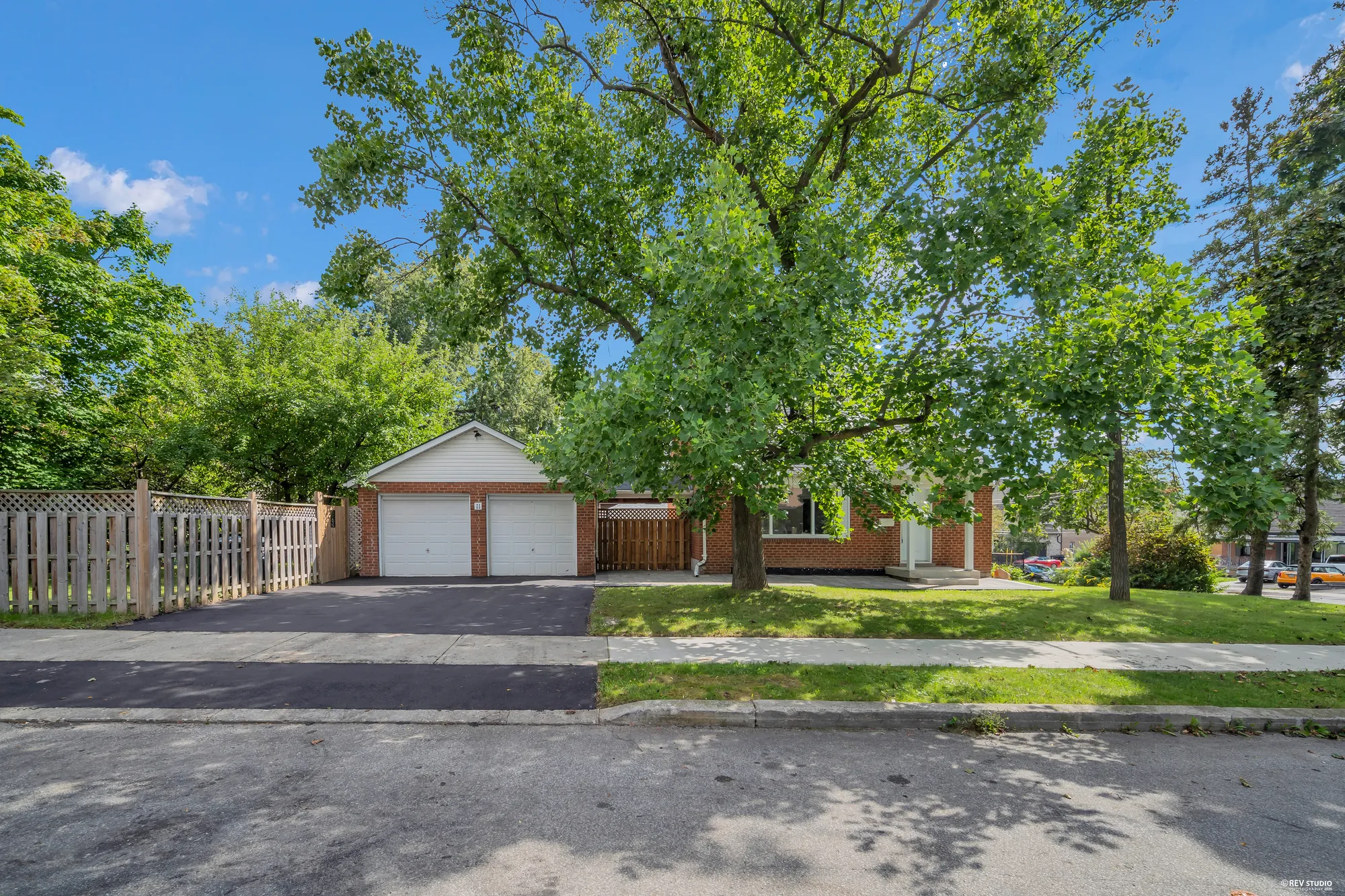 The drive along the side of the lot leading to the detached double garage