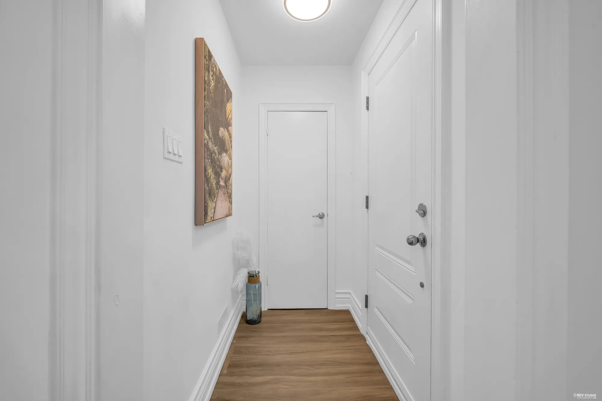 The front hall with the front door at the end