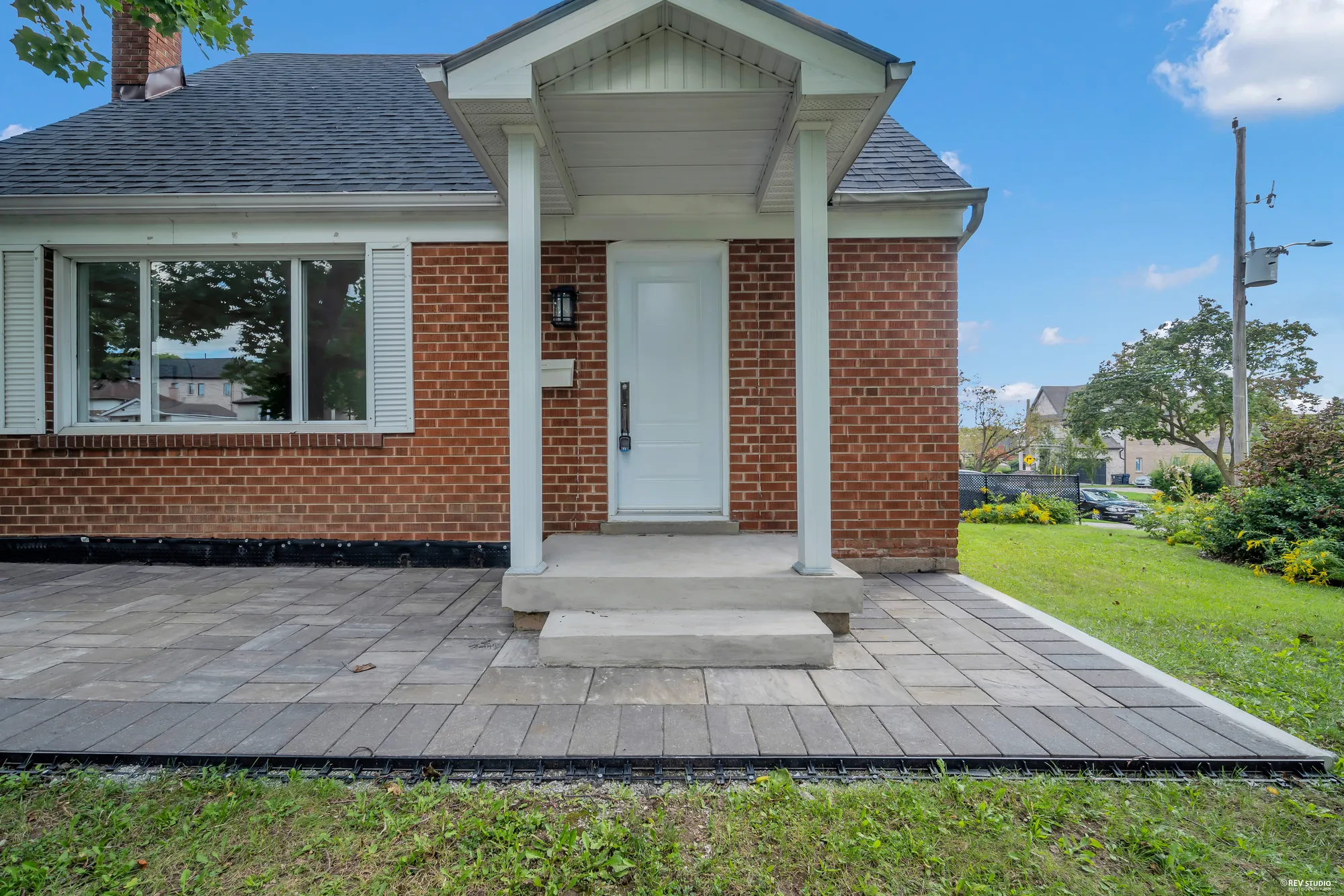 The front entrance with a gabled porch over the step and a stone walk