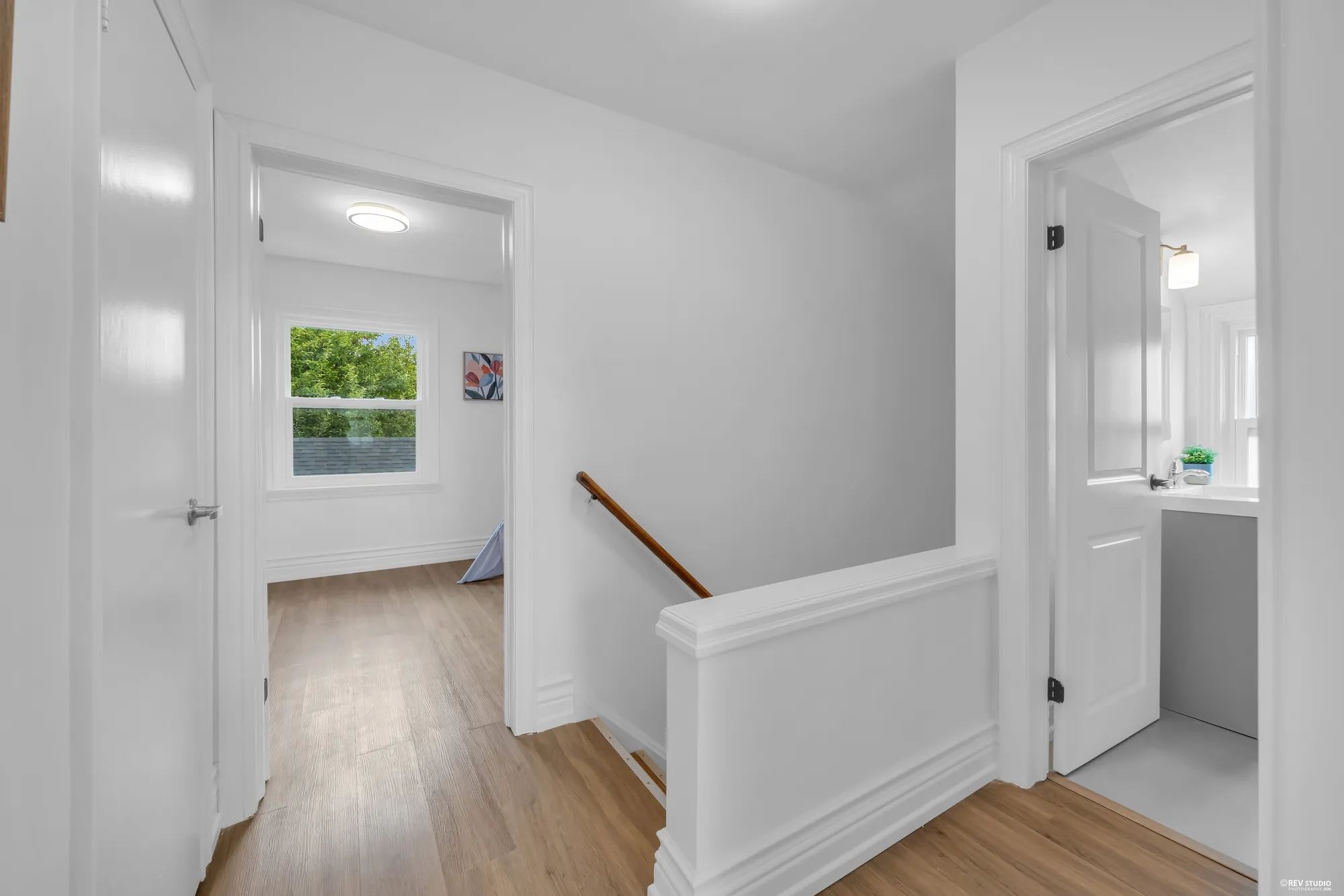 The upstairs landing with a bedroom door on one side and the bathroom on the other